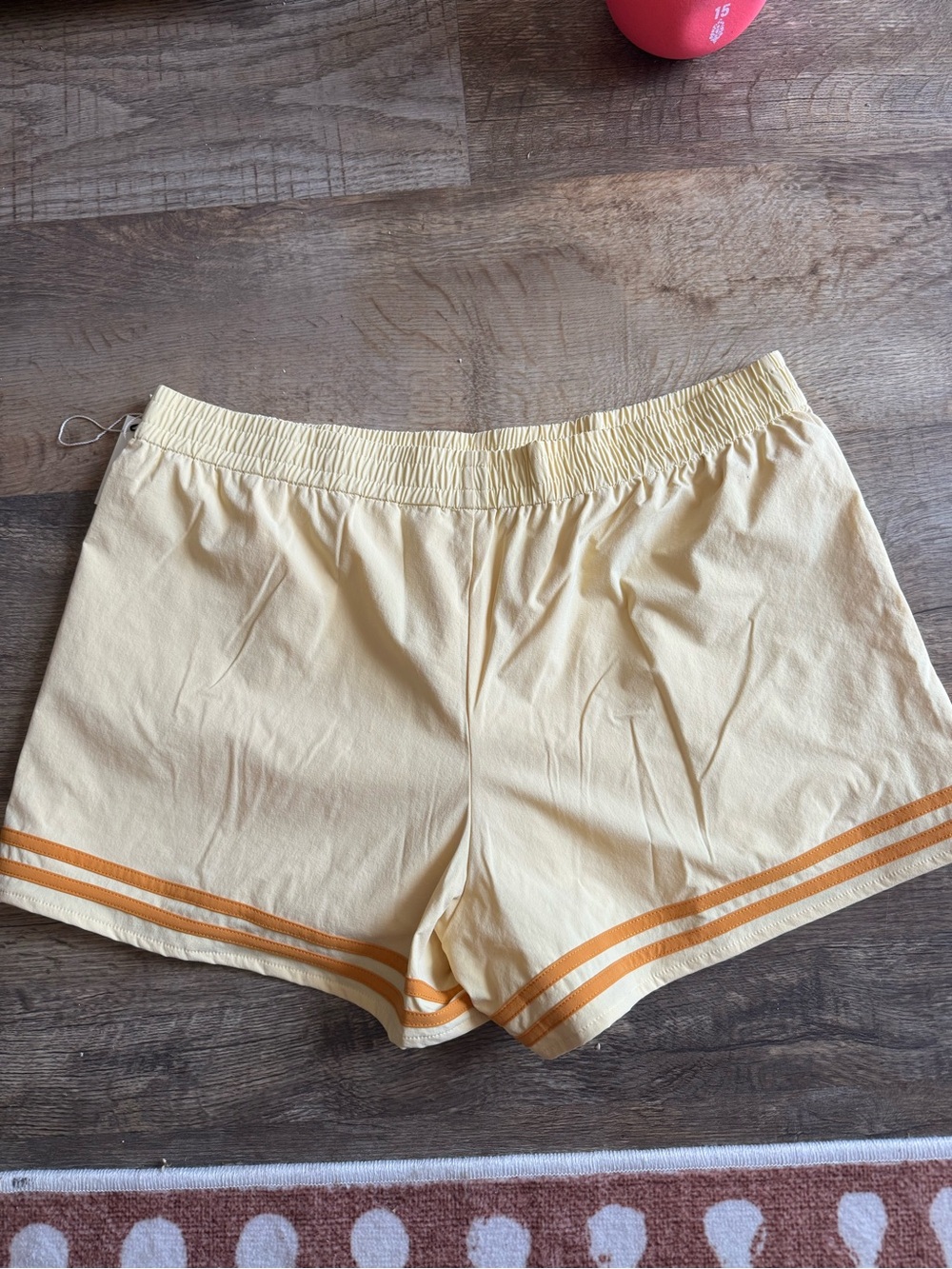 SET Active Pale Yellow Athletic Shorts with Orange Hem Stripes